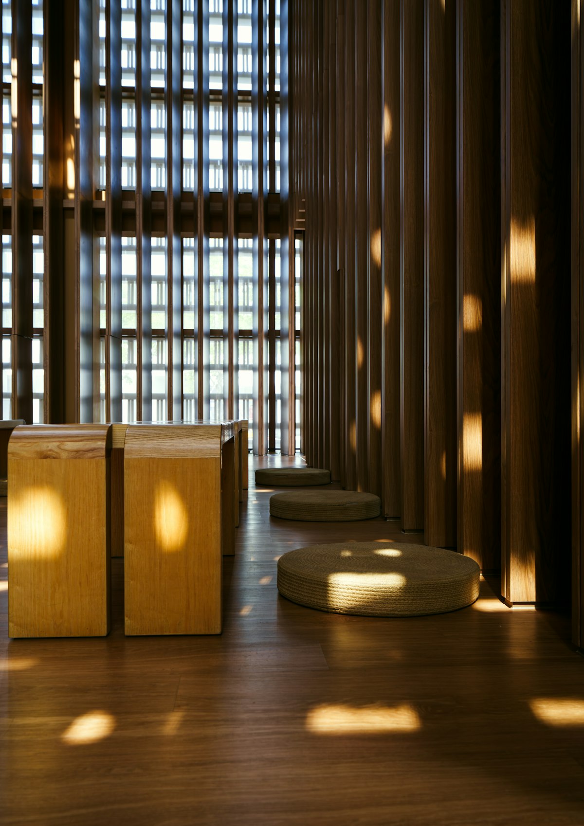 Hallway lined with vertical wooden slats and warm wall lights