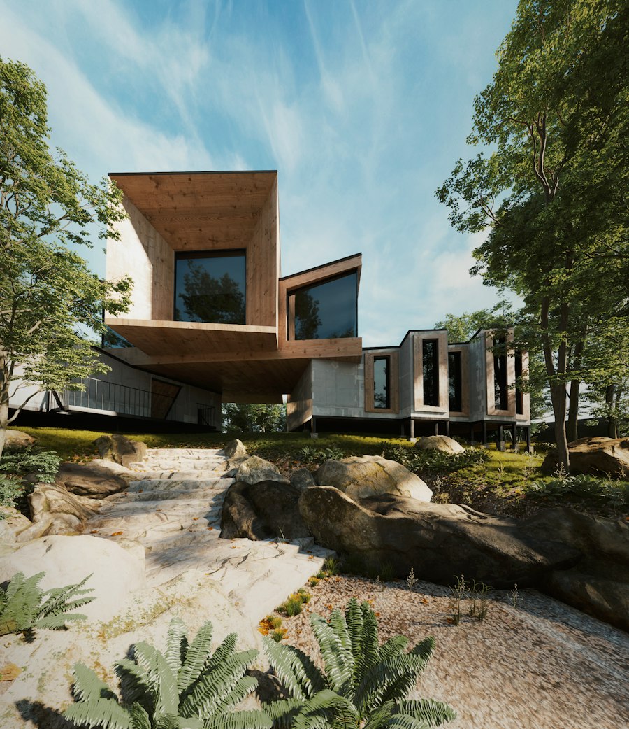 Stepped concrete and timber house among boulders and trees on a hillside